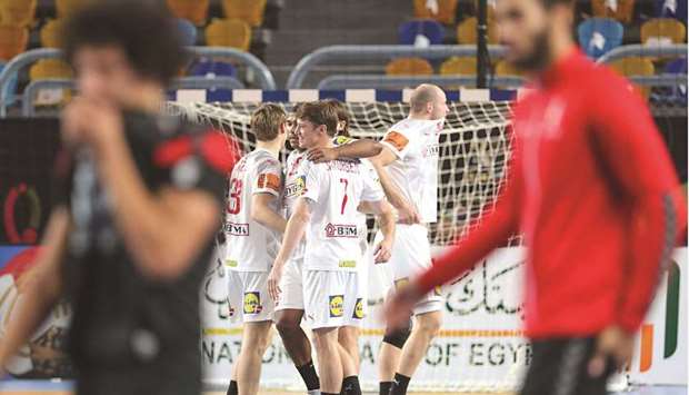 Denmarku2019s players celebrate their win in the 2021 IHF World Menu2019s Handball Championship quarter-final against Egypt in Cairo, Egypt, yesterday. (AFP)