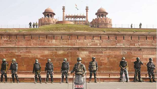 Policemen stand guard in front of the Red Fort after Tuesdayu2019s clashes between police and farmers, in the old quarters of Delhi, yesterday.