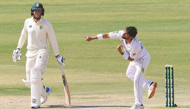 Pakistanu2019s Yasir Shah (R) bowls as South Africau2019s Rassie van der Dussen watches during the third day of the first cricket Test match at the National Stadium in Karachi yesterday.