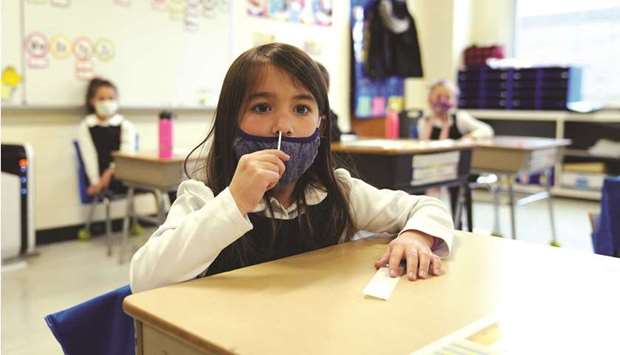 SELF-EXAMINATION: Schoolchildren in a classroom at South Boston Catholic Academy in Boston, Massachusetts, US, swab and test themselves yesterday for Covid-19.