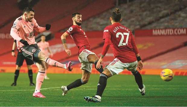 Sheffield Unitedu2019s Oliver Burke (left) scores against Manchester United in the Premier League at Old Trafford in Manchester, north west England, on Wednesday night. (AFP)