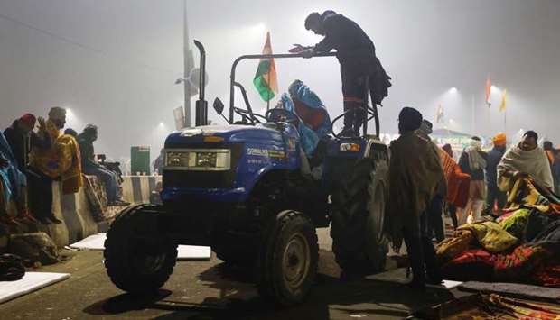 Farmers arrive with blankets and mattresses for others at the site of a protest against farm laws at Ghaziabad, India