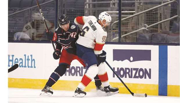 Columbus Blue Jackets' Alexandre Texier (left) and Florida Panthers' Anton Stralman battle for puck during the NHL match in Columbus, Ohio on Thursday. (AFP)