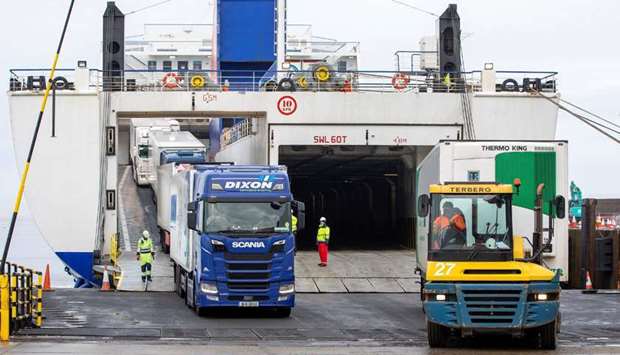 Freight lorries and HGVs (L) and unaccompanied freight (R) disembark from the Stena Line ferry 'Kerry', after arriving at the port of Rosslare Harbour in Rosslare, southeast Ireland