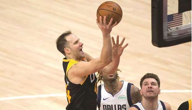 Utah Jazz forward Bojan Bogdanovic shoots the ball during their NBA game against Dallas Mavericks at Vivint Smart Home Arena. (Right) Kawhi Leonard of the LA Clippers drives to the net during the third quarter against the Orlando Magic at Amway Center in Orlando, Florida. PICTURES: USA TODAY Sports and Getty Images/AFP)
