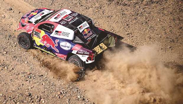 Qataru2019s Nasser al-Attiyah of Qatar and his co-driver Mathieu Baumel of France compete during the prologue at the Dakar Rally in Jeddah yesterday.  (AFP)