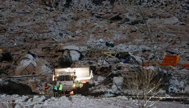 Rescue crews work at the site of a landslide in Ask in Gjerdrum,on January 2, following a landslide in the town some 40 km northeast of the capital Oslo.