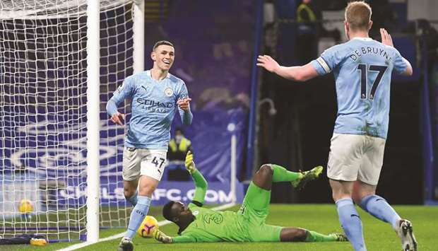 Manchester Cityu2019s Phil Foden (left) celebrates scoring their second goal with Kevin De Bruyne (right) during the English Premier League match against Chelsea at Stamford Bridge in London, United Kingdom, yesterday. (Reuters)
