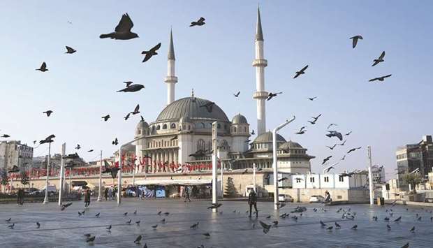 Pigeons fly over the Taksim Square during a nation-wide weekend curfew imposed to prevent the spread of the coronavirus disease in Istanbul on December 5, 2020. Turkish annual inflation rose more than expected to 14.6% in December as food costs jumped, official data showed on Monday, keeping pressure on the central bank for tight policy even after it sharply hiked interest rates at the end of 2020.