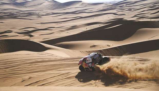 Qataru2019s Nasser Saleh al-Attiyah and co-driver Mathieu Baumel of France compete during Stage 2 of the Dakar Rally between Bisha and Wadi ad-Dawasir in Saudi Arabia yesterday. (AFP)