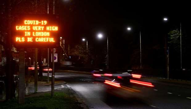 A government public health information message is seen on a roadside sign, amidst the spread of the coronavirus disease pandemic, in London
