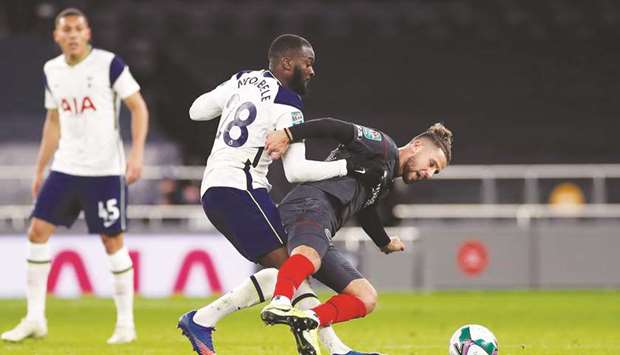 Brentfordu2019s Emiliano Marcondes (right) is fouled by Tottenham Hotspuru2019s Tanguy Ndombele during the League Cup  semi-final in London on Tuesday. (Reuters)