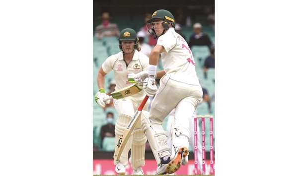 Australian batsmen Will Pucovski (left) and Marnus Labuschagne run between the wickets on day one of the third Test against India at the Sydney Cricket Ground yesterday. (AFP)