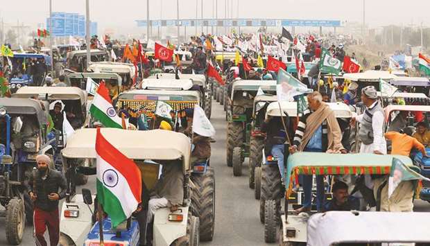 Farmers participate in a tractor rally to protest against the newly passed farm bills on the outskirts of the capital New Delhi.