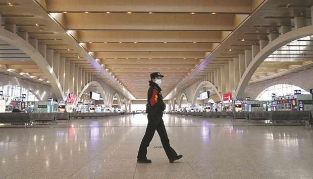 A police patrol walking at an empty railway station as the city cuts outside transport links and bans residents from leaving, after the largest domestic Covid-19 coronavirus outbreak in six months in Shijiazhaung, in northern Chinau2019s Hebei province on January 7. Virus relief measures that are u201cpotentially distortionaryu201d should be gradually phased out, the IMF said in its annual Article IV report on Friday.