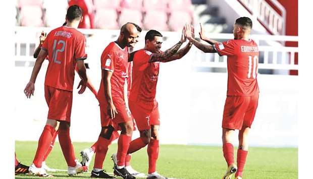 Al Duhailu2019s Dudu (second right) celebrates with teammate Edmilson after scoring against Al Wakrah yesterday.