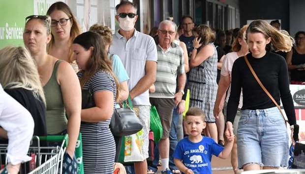 People line up to enter a grocery store before an impending lockdown due to an outbreak of the coronavirus disease in Brisbane, Australia
