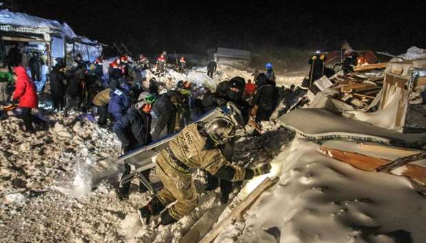 Russian Emergency ministry rescuers work at the avalanche site in the town of Talnakh.