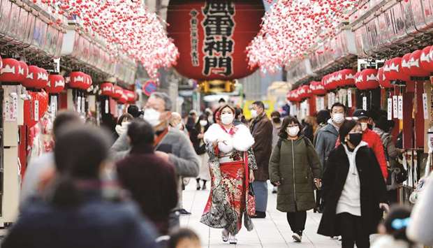 A woman wearing kimono makes her way at Asakusa district, amid the coronavirus disease outbreak in Tokyo on Friday. The government has resisted calls from some experts for wider curbs beyond those imposed in Tokyo because of the economic pain they would cause.
