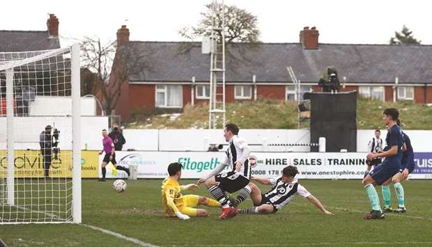 Chorleyu2019s Mike Calveley scores against Derby County during the FA Cup third round match at Victory Park in Chorley, Britain, yesterday. (Reuters)