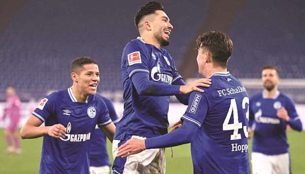 Schalkeu2019s Matthew Hoppe (right) celebrates with teammates after scoring against Hoffenheim in Gelsenkirchen, western Germany, yesterday. (AFP)