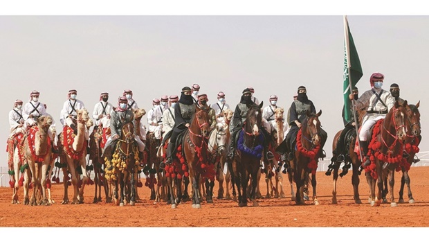 Saudi cameleers and horsewomen take part in a parade during the sixth edition of the King Abdulaziz Camel Festival in the Rumah region, some 161km east of the capital Riyadh, on Saturday.