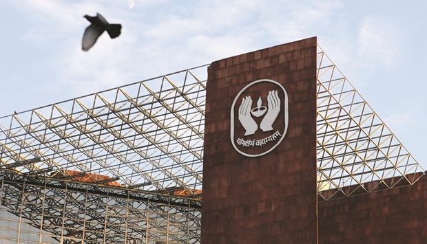 A bird flies past a logo of Life Insurance Corporation of India (LIC) at one of its offices in New Delhi. Prime Minister Narendra Modiu2019s government has the IPO u2013 which could raise between 400bn rupees ($5.4bn) and 1tn rupees this quarter u2013 as a key item in its economic agenda, with proceeds from the state-run insurer key to reaching a budget-deficit target.