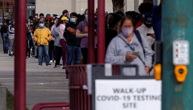People wait outside a community center as long lines continue for individuals trying to be tested for Covid-19 in San Diego.