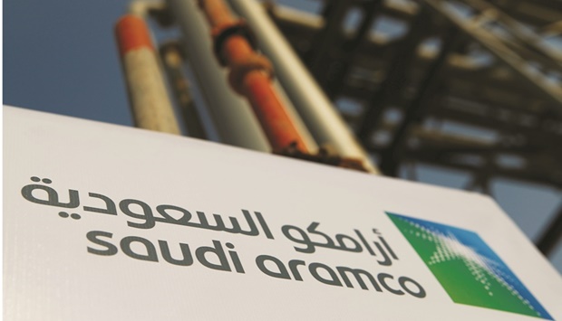 The Saudi Aramco logo is pictured at the oil facility in Abqaiq, Saudi Arabia. Aramco will buy 30% of a refinery on the Baltic coast, as well as a wholesale fuel unit. It also signed a long-term delivery deal with Polish refiner PKN Orlen.