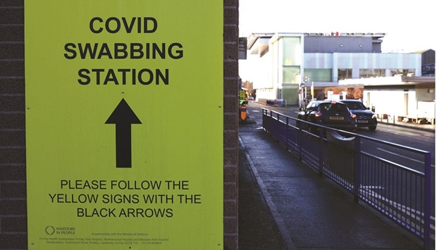 Cars go past a Covid-19 swabbing station signage outside the Frimley Park Hospital in Surrey on January 13. British Education Secretary Nadhim Zahawi on Sunday told the BBC that the UK is u201con a path towards transitioning from pandemic to endemic.u201d