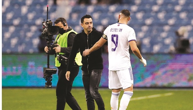Real Madridu2019s Karim Benzema with Barcelona coach Xavi after the Spanish Super Cup semi-final at the King Fahd International Stadium, Riyadh in Saudi Arabia on Wednesday. (Reuters)