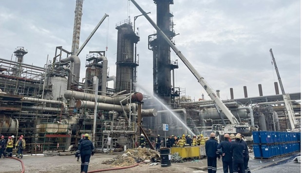 Firefighting personnel extinguishing the fire at al-Ahmadi refinery south of Kuwait City. AFP/ KNPC