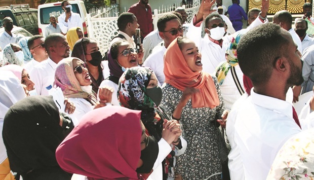 Dozens of Sudanese doctors demonstrate in Khartoum to denounce attacks by security forces against medical personnel and doctors during pro-democracy rallies opposed to the October military coup, yesterday.