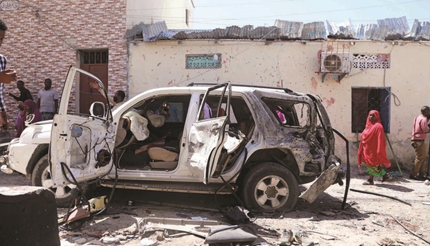 The vehicle wreckage of Somaliau2019s government spokesperson Mohamed Ibrahim is seen at the scene of an explosion in Mogadishu, yesterday.