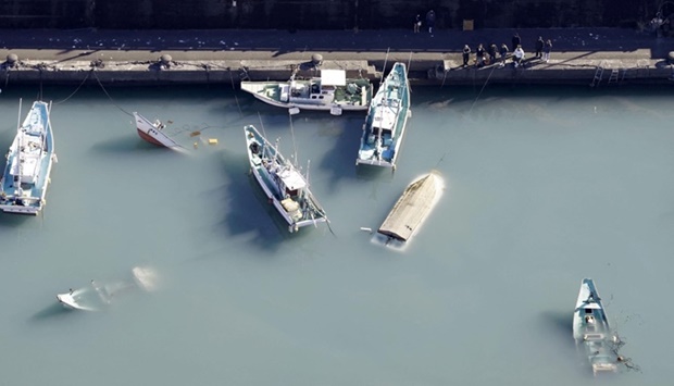 An aerial view shows capsized boats believed to be affected by the tsunami caused by an underwater volcano eruption on the island of Tonga at the South Pacific, in Muroto, Kochi prefecture, Japan,on January 16. Kyodo/via REUTERS