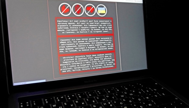 A laptop screen displays a warning message in Ukrainian, Russian and Polish, that appeared on the official website of the Ukrainian Foreign Ministry after a cyberattack, in this illustration taken January 14. REUTERS/Valentyn Ogirenko/Illustration/File Photo