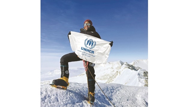 Sheikha Asma al-Thani holds the UNHCR flag at the South Pole, Antarctica.