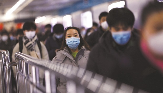 People walk at a subway station during morning rush hour, as the coronavirus pandemic continues in the country, in Beijing, on January 17. The economy grew 8.1% last year u2014 its best expansion since 2011 u2014 and faster than a forecast 8.0%.