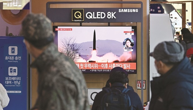 People watch a television screen showing a news broadcast with file footage of a North Korean missile test, at a railway station in Seoul yesterday.