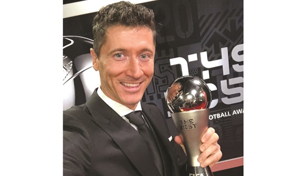 Bayern Munichu2019s striker Robert Lewandowski celebrates with the FIFAu2019s top menu2019s player trophy in Zurich yesterday. (@lewy_official)