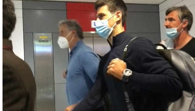 Novak Djokovic (C) as he disembarks from his plane at the airport in Dubai on January 17. AFPTV/AF