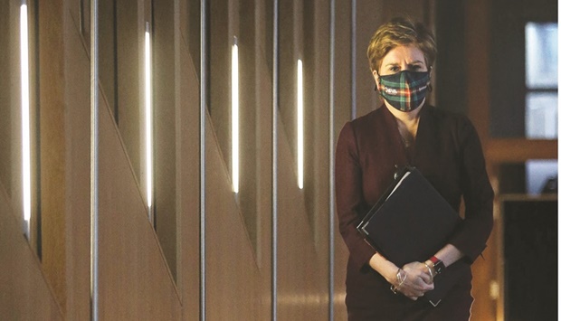 First Minister Nicola Sturgeon wearing a face covering to combat the spread of the coronavirus, arrives to give an update on the Covid-19 situation in the Scottish Parliament at Holyrood in Edinburgh yesterday.