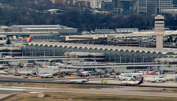 American Airlines and American Eagle planes sit at Ronald Reagan Washington National Airport in Arlington, Virginia on January 18, as seen from Washington, DC.