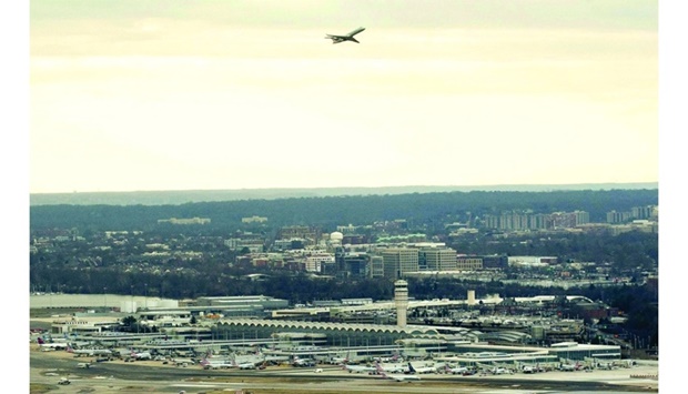 A passenger aircraft takes off from Ronald Reagan National Airport in Arlington, Virginia, on January 18 as seen from Washington, DC. Airlines have warned that the fifth-generation wireless technology, widely known as 5G, could interfere with sensitive airplane instruments such as altimeters, significantly hampering low-visibility operations and grounding planes.