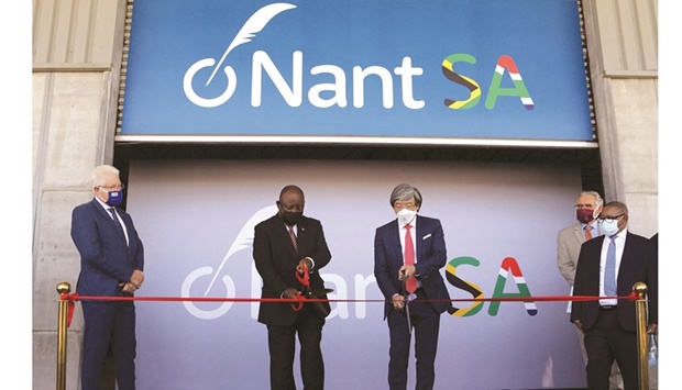 South African President Cyril Ramaphosa and Dr Patrick Soon-Shiong cut a ribbon, while Premier of the Western Cape Alan Winde looks on, during the launch of NantSA, a future vaccine manufacturing facility, in Cape Town, yesterday.