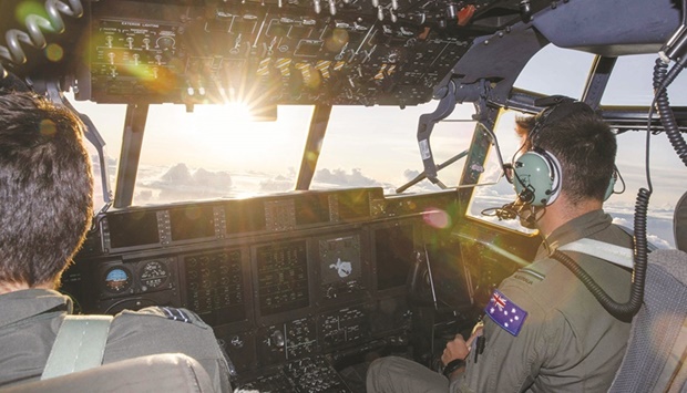 This handout photo released by the Royal Australian Air Force and the Australian Defence Force shows No. 37 Squadron pilots Flight Lieutenant Jack Woodrow (left) and Flying Officer John Newell flying along the coastline of Tonga to assess damage following the eruption of the Hunga Tonga-Hunga Haau2019pai underwater volcano on January 15.