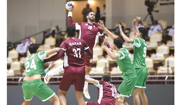 Qatar players in action during their match against Iraq at the Asian Menu2019s Handball Championship in Dammam, Saudi Arabia, yesterday.