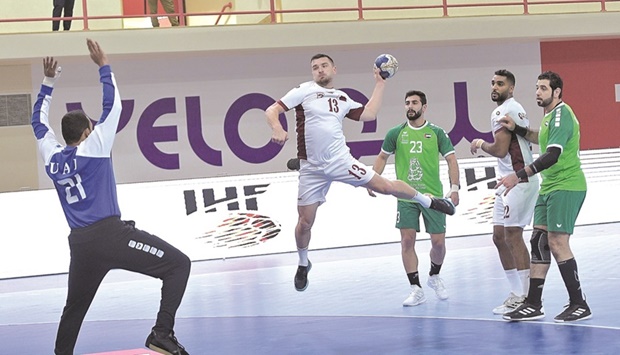 A Qatari player prepares to shoot at the goal during the match against United Arab Emirates at the Prince Nayef Sports City Hall, in Qatif, Saudi Arabia.