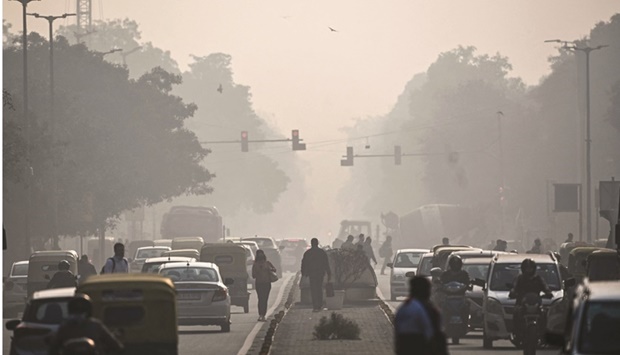 People commute along a street amid smoggy conditions in New Delhi (file). Retail inflation in India rose for a third month in December, and more pain may be on the way. The countryu2019s consumer prices this year are expected to grow the fastest among the worldu2019s 10 largest economies, according to a Bloomberg survey.