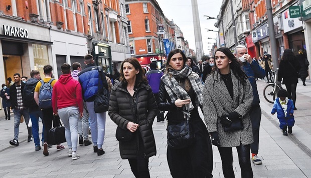People not wearing masks walk in the city centre, as the coronavirus disease (Covid-19) restrictions begin to ease, in Dublin, Ireland.